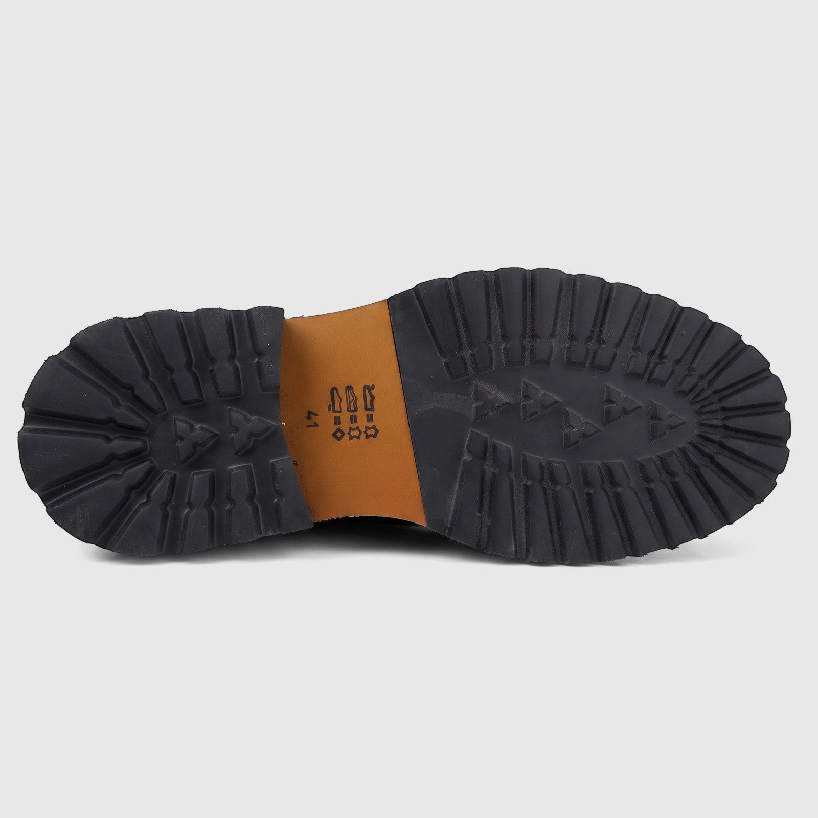 View of the black chunky lug sole and brown mid-sole of a Formales men's leather lace-up boot, size 41, from below.