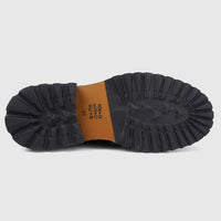 View of the black chunky lug sole and brown mid-sole of a Formales men's leather lace-up boot, size 41, from below.