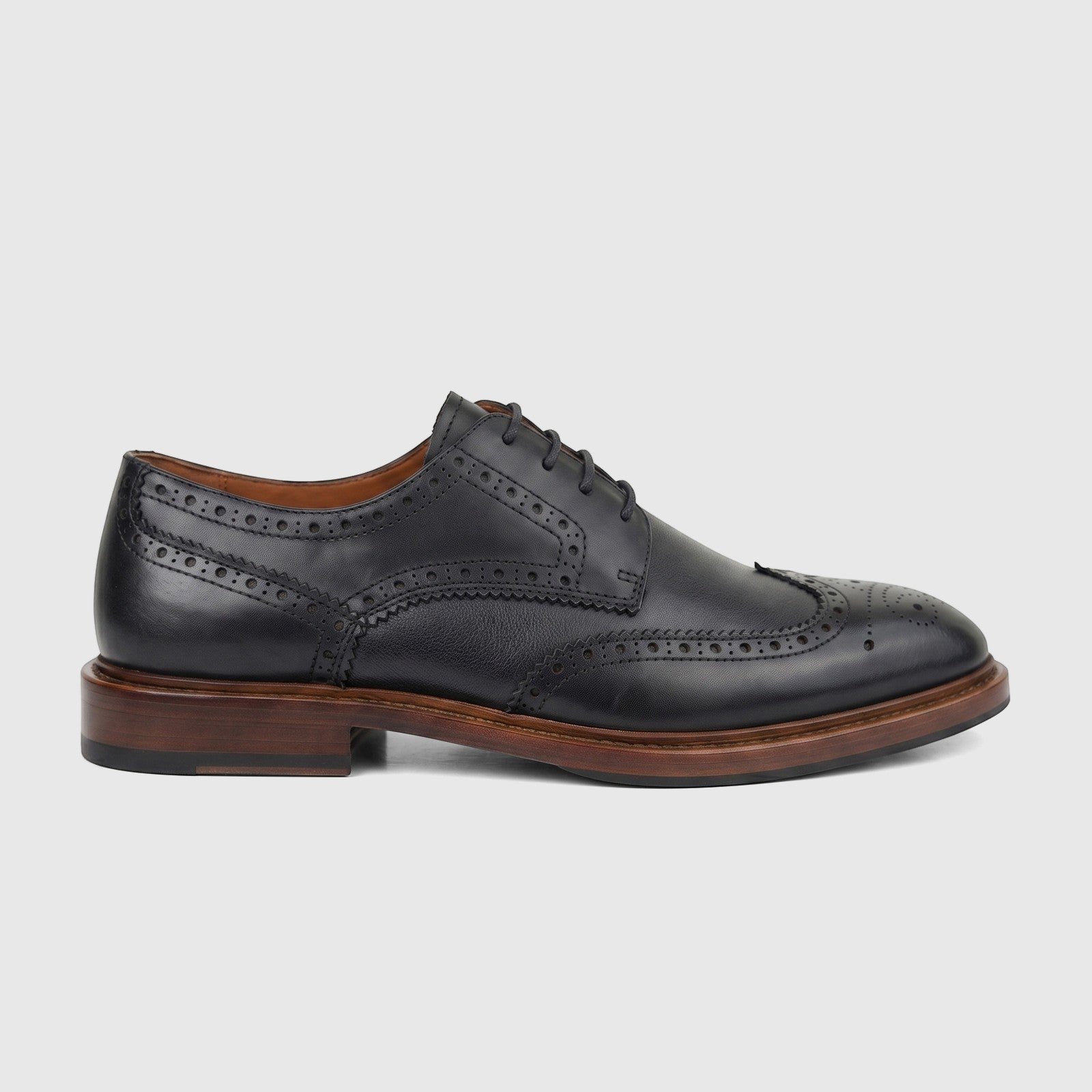 A single black leather Formales Men's Lace Up Brogue shoe with a chunky brown sole and perforated detailing, shown in a side