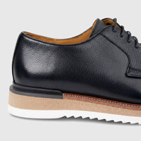 Close-up view of a Formales Men's Leather Chunky Sole Lace Up shoe in black, featuring a textured upper and a layered,