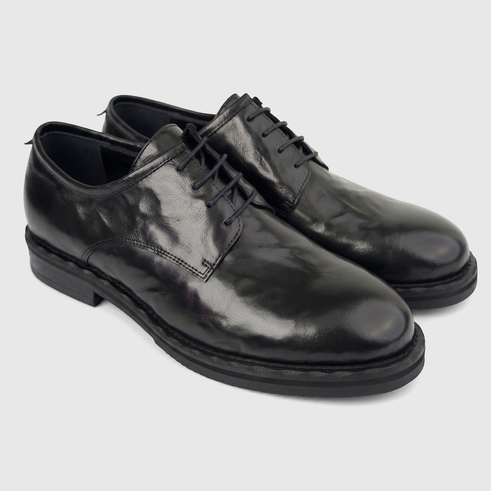 Formales Men's black leather lace-up shoes with chunky soles, featuring a sleek design and shiny finish, presented in an