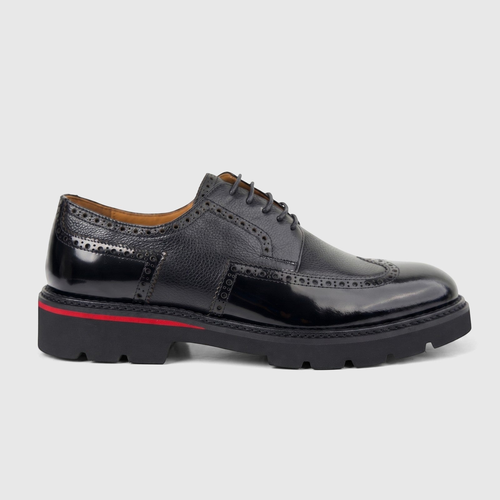 Black men's formal lace-up shoe with a chunky lug sole and brogue details, crafted from textured and patent leather, shown