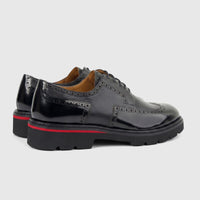 Pair of Formales men's black leather chunky sole lace-up shoes with brogue details and a red stripe, viewed from the