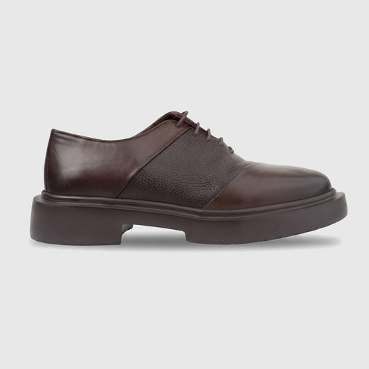 Brown leather men's formal lace-up shoe with a chunky sole, shown in a side view on a white background.