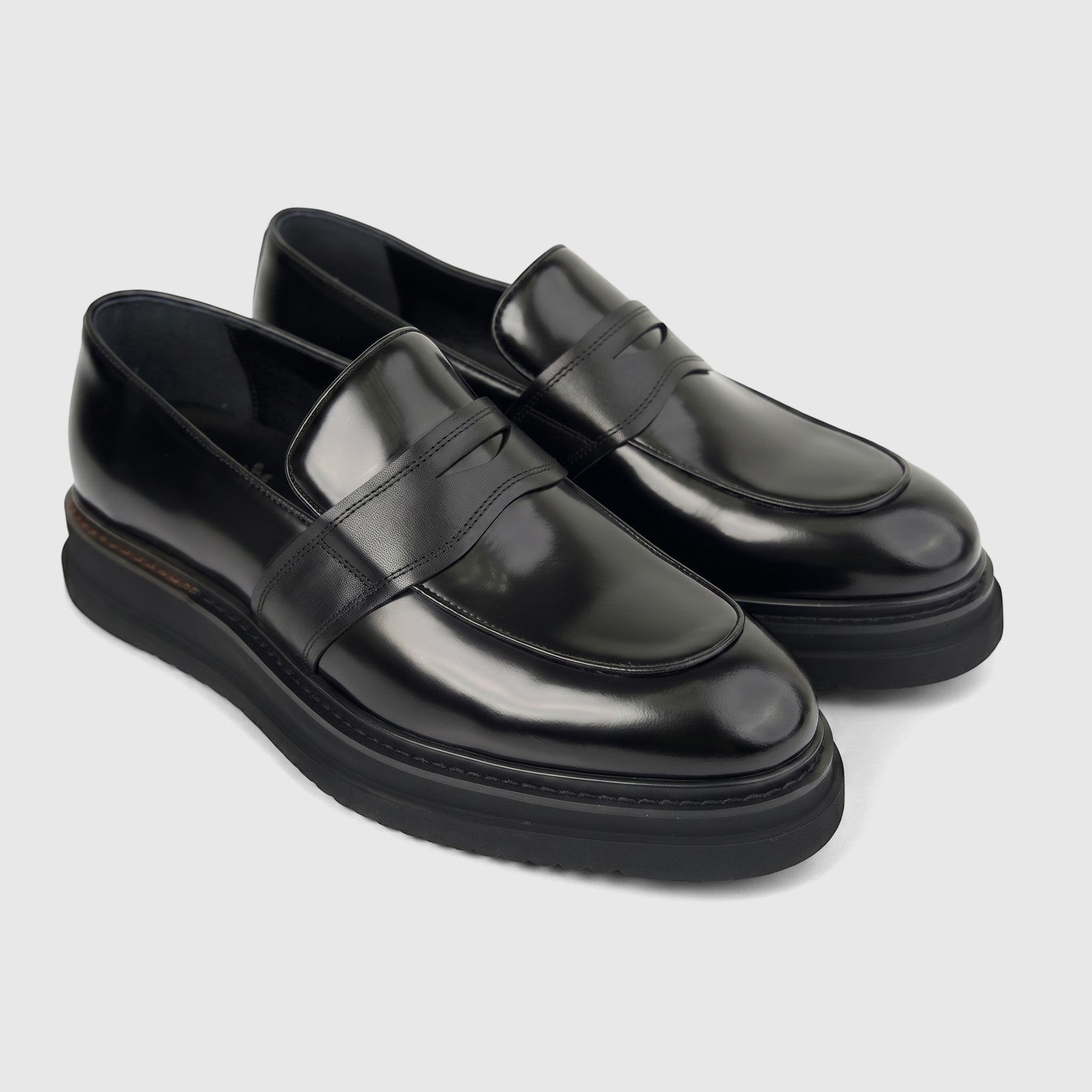 Pair of Formales Men's Leather Chunky Sole Slip On loafers in black, showcasing a shiny finish and robust design.