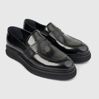 Pair of Formales Men's Leather Chunky Sole Slip On loafers in black, showcasing a shiny finish and robust design.