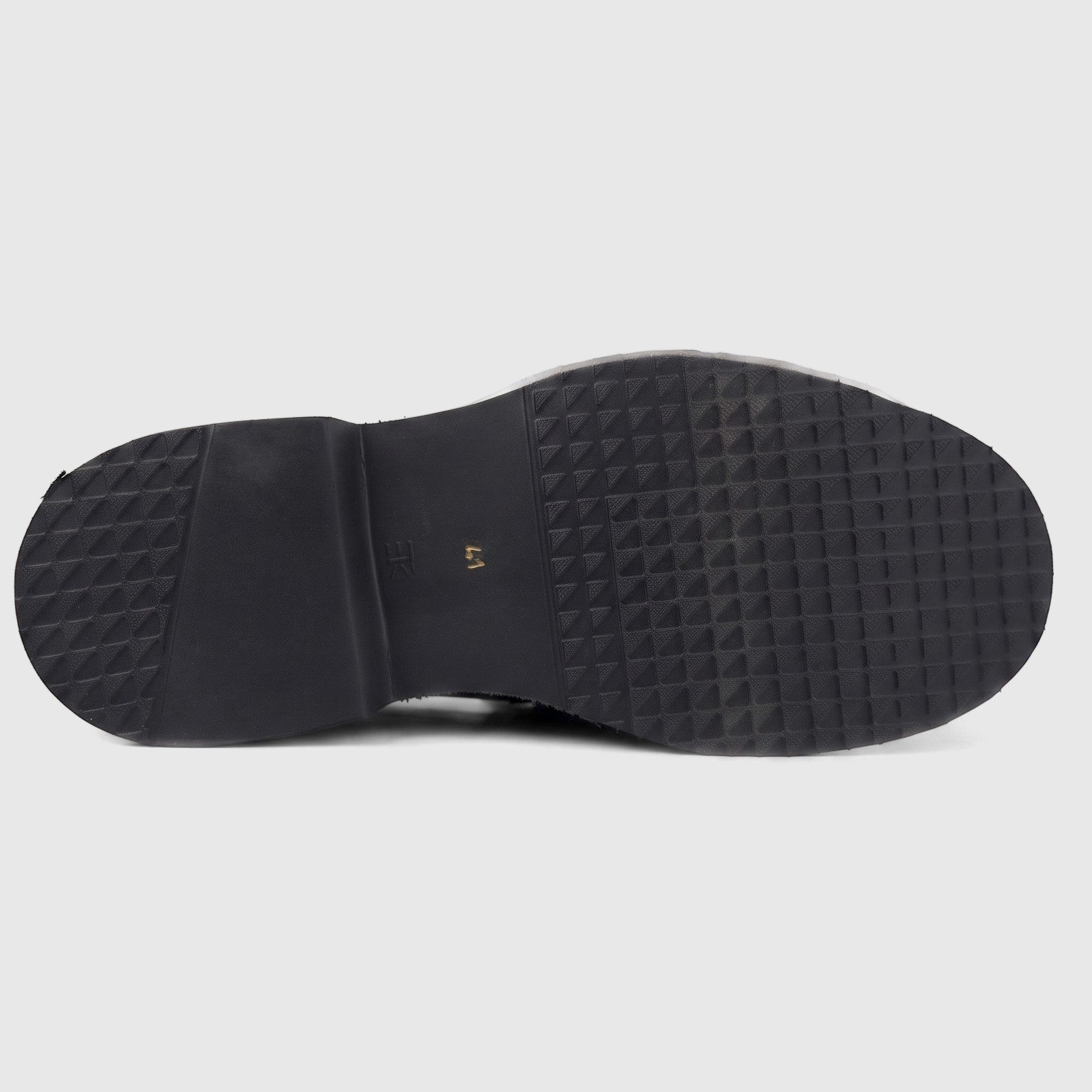 Formale's men's black leather slip-on shoe with a chunky, textured sole, viewed from the underside.