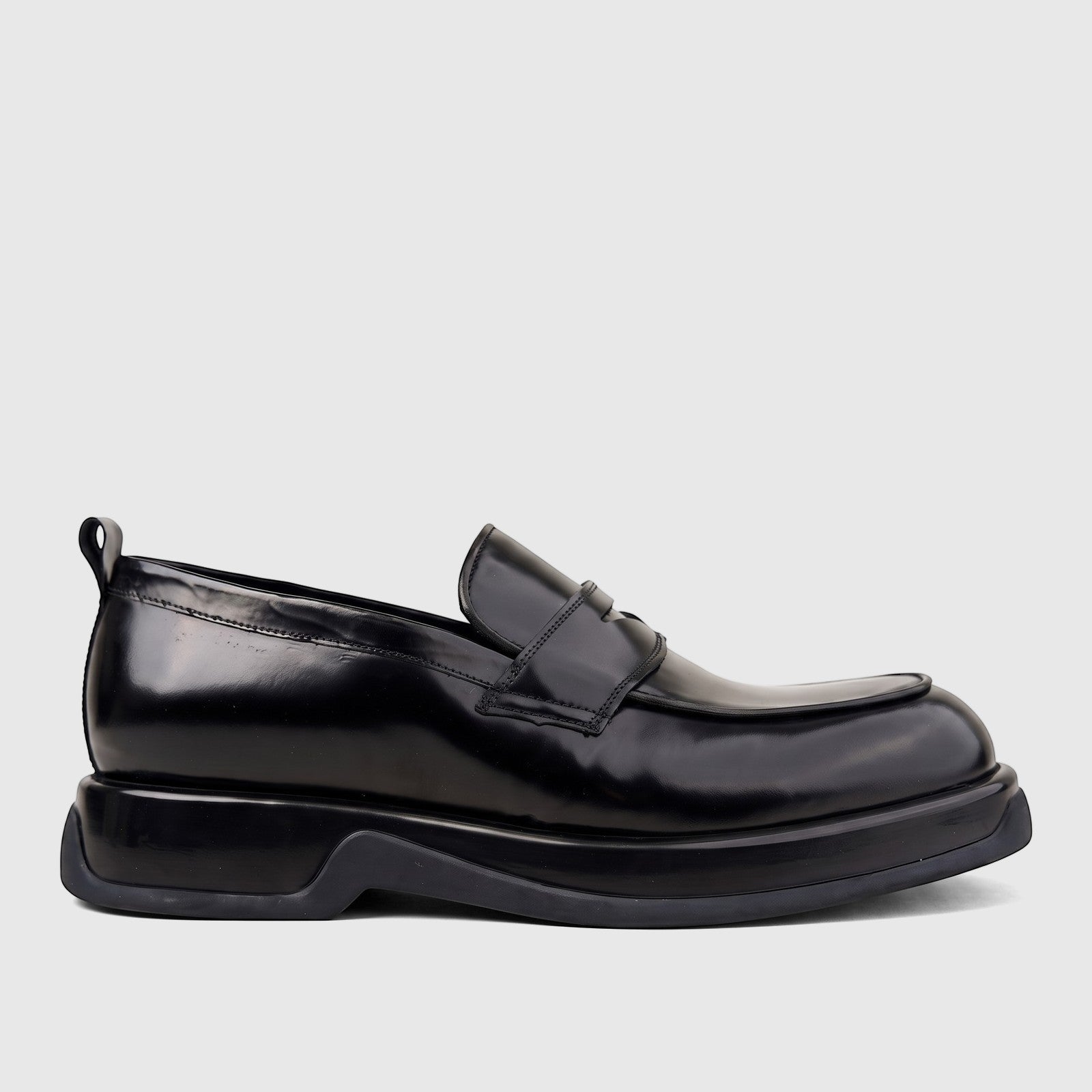 Black high-shine formal men's slip-on loafer with a chunky sole, presented in a side profile view.