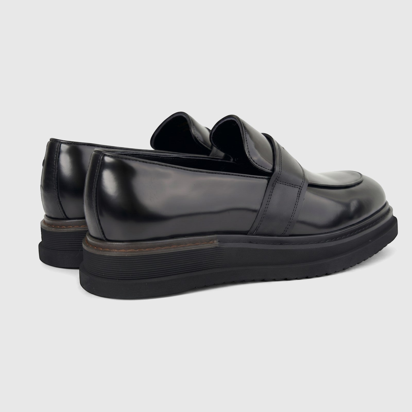 Black Formale men's leather chunky sole slip-on shoes, viewed from a slightly elevated rear-side angle on white.