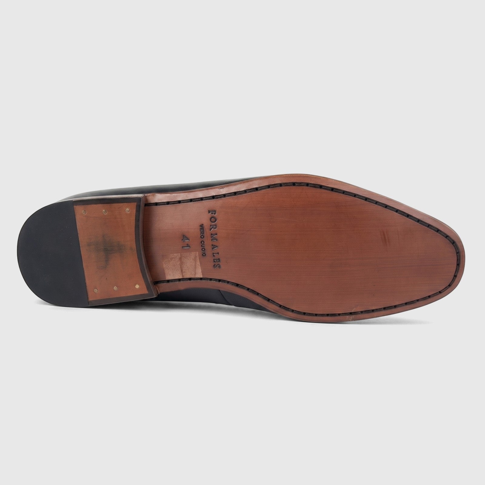 Bottom view of a Formales Men's Leather Dress Slip On shoe in black, showcasing the brown leather sole with brand details