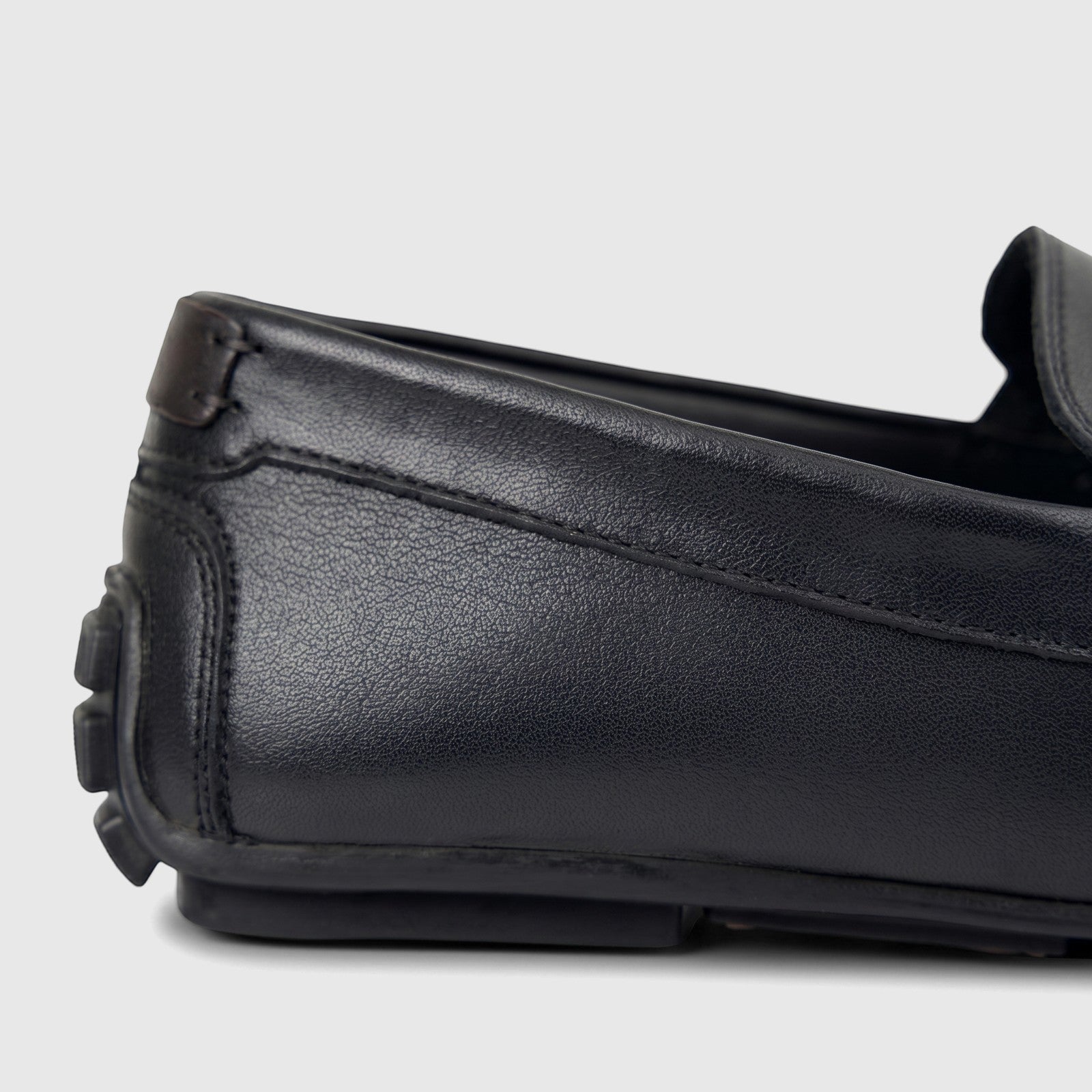 Close-up side view of a Formales Men's Leather Loafer FT268017 in black, showcasing its textured leather, detailed