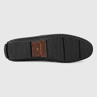 Bottom view of a Formales men's black leather loafer, showcasing the ribbed rubber sole with a brown patch displaying