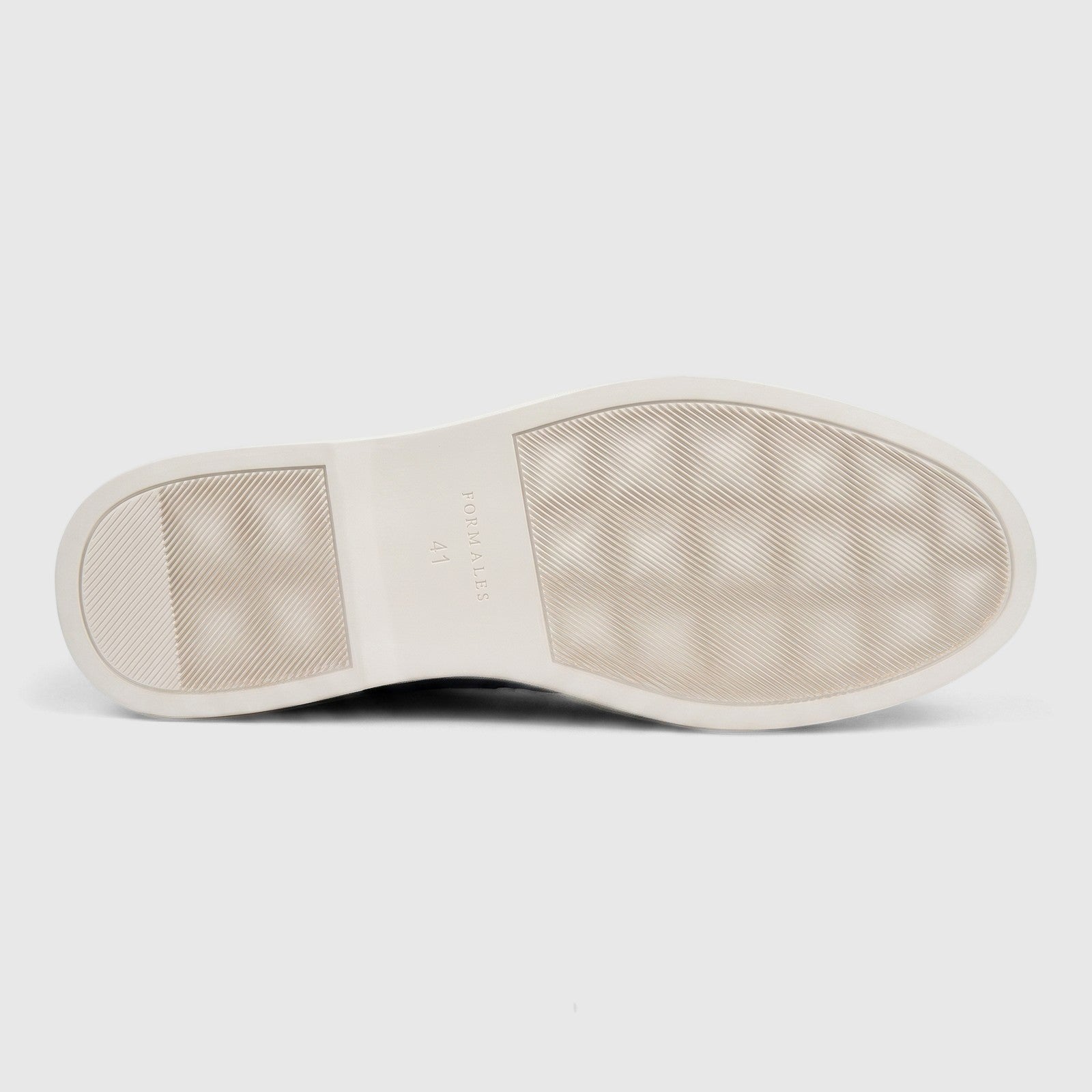 Bottom view of a Formales Men's Leather Loafer with a textured off-white sole featuring a diagonal line pattern.