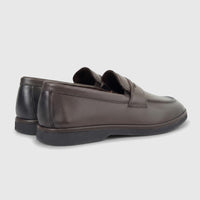 A pair of Formales men's coffee brown leather loafers with black soles, viewed from a rear-quarter angle on a white