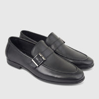 Pair of black leather men's loafers with a silver buckle detail, presented on a white background, ideal for formal wear.
