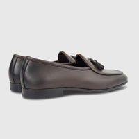 A pair of dark brown Formales Men's Leather Loafers FT268006, featuring tassels, presented from a side angle.
