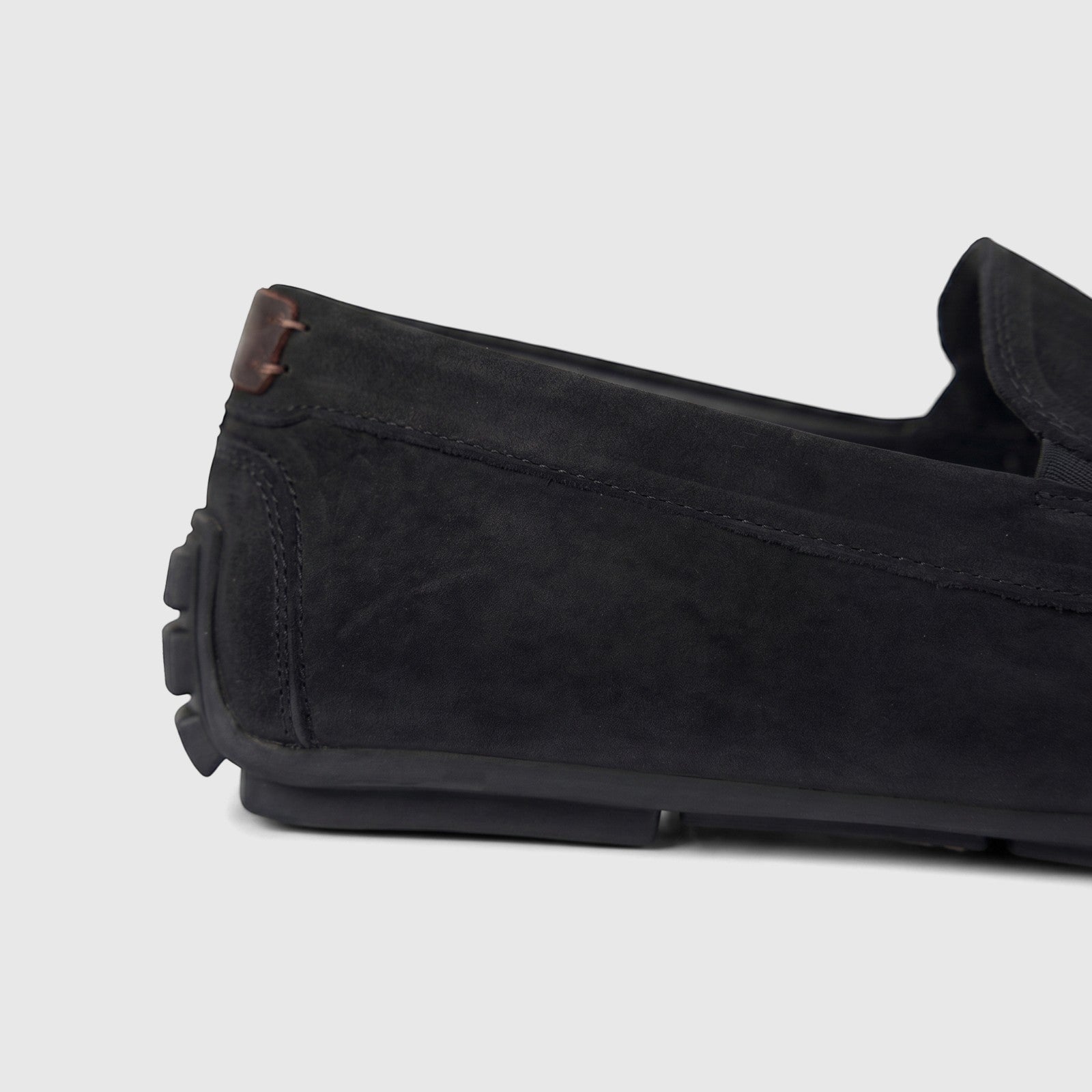 Close-up side view of a black Formale's men's leather loafer, highlighting the texture and stitching details.