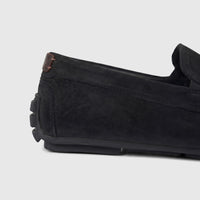 Close-up side view of a black Formale's men's leather loafer, highlighting the texture and stitching details.