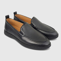 Black Formales men's leather loafers with ribbed vamps, seen from a slightly angled view.