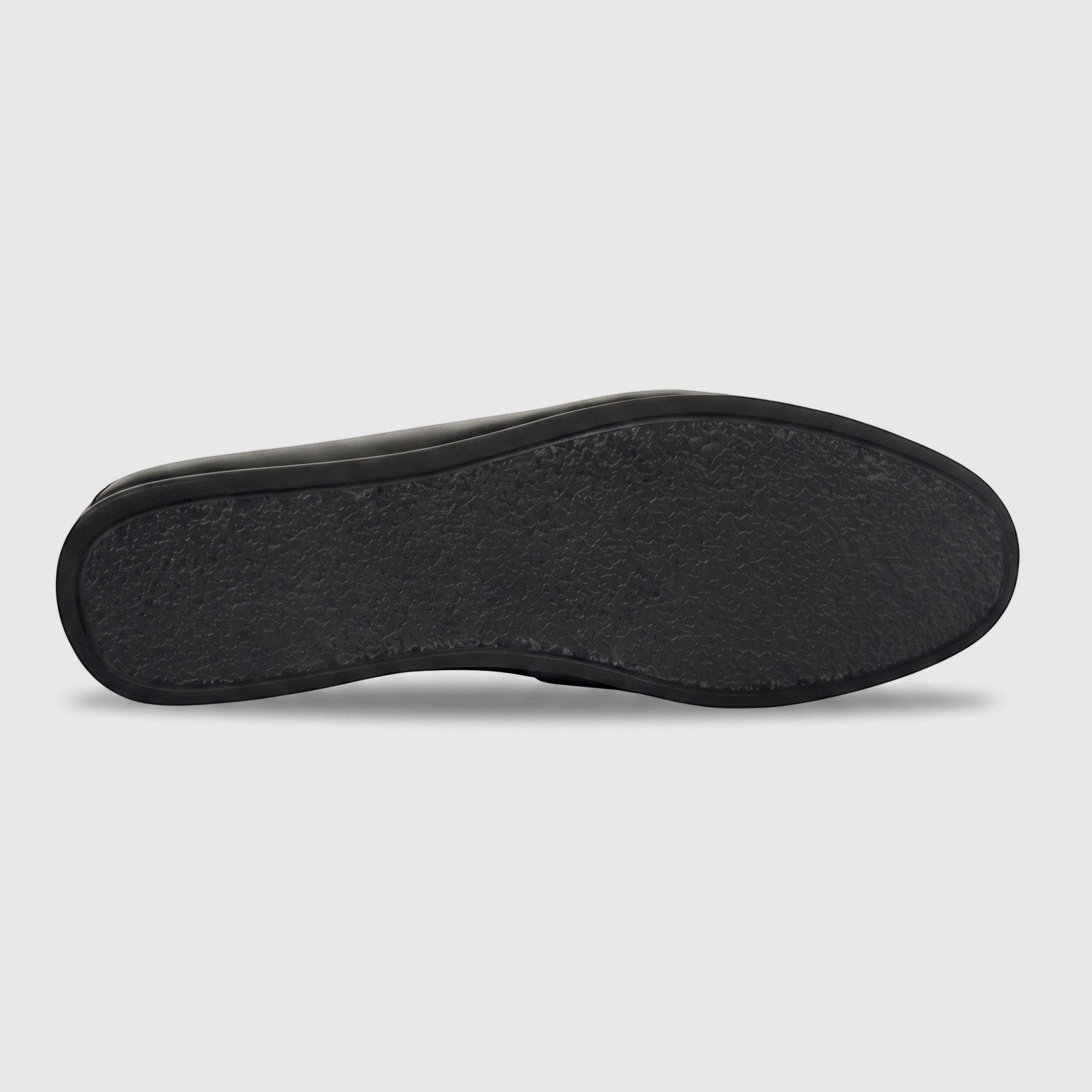 Bottom view of a Formales men's black leather slip-on shoe, showcasing the textured sole for enhanced grip and durability.