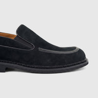 Close-up side view of a Formales Men's Leather Slip On FW267011 Black FW1 shoe, featuring black suede and a distinct sole.