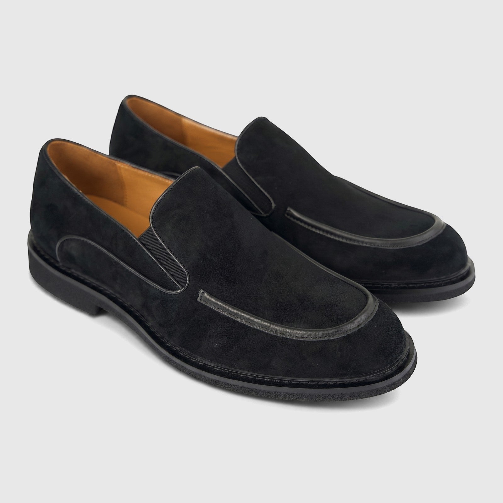 A pair of black suede Formales Men's Slip On loafers with leather detailing and tan interior lining.
