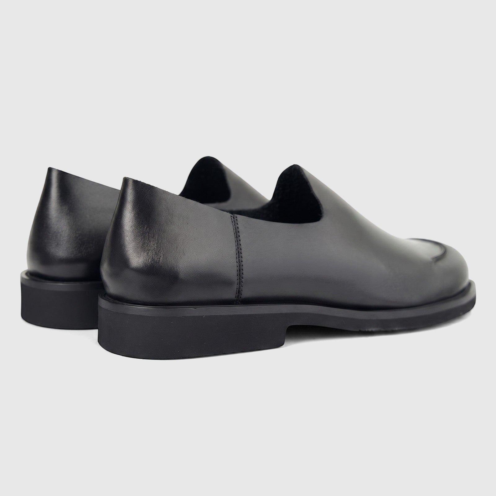 Formules Men's Leather Slip On shoes in black, featuring a smooth leather upper and a sturdy sole, viewed from a