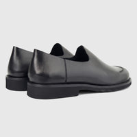 Formules Men's Leather Slip On shoes in black, featuring a smooth leather upper and a sturdy sole, viewed from a