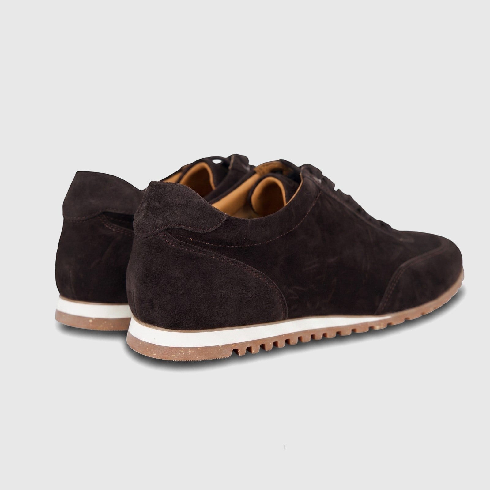 Pair of Formales men's low-top leather sneakers in dark brown suede, viewed from the rear on a white background.