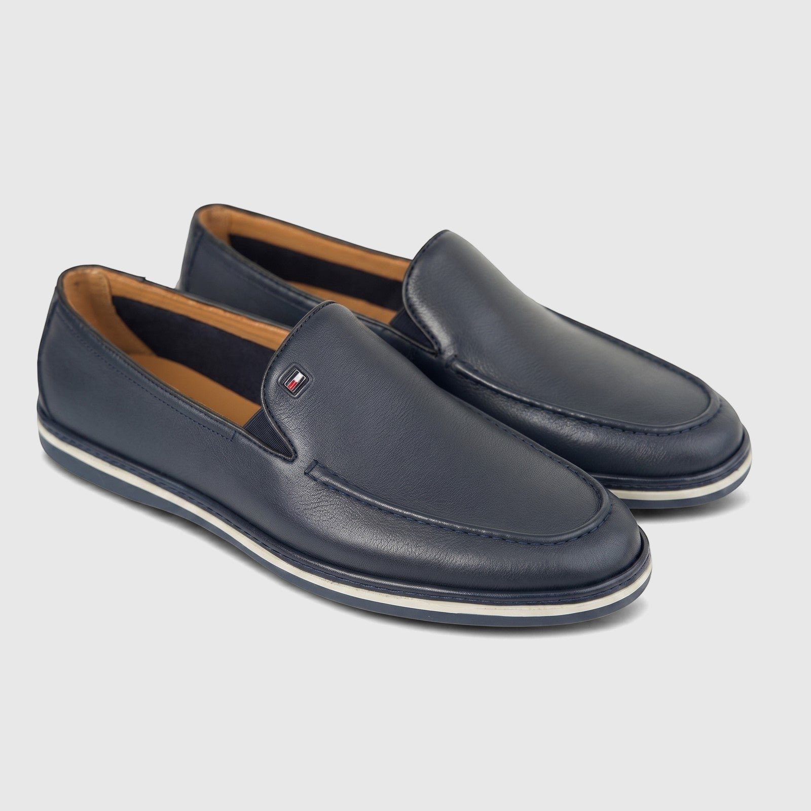 Pair of Formales men's navy blue leather loafers, featuring moc-toe stitching and a subtle side logo, displayed on a white