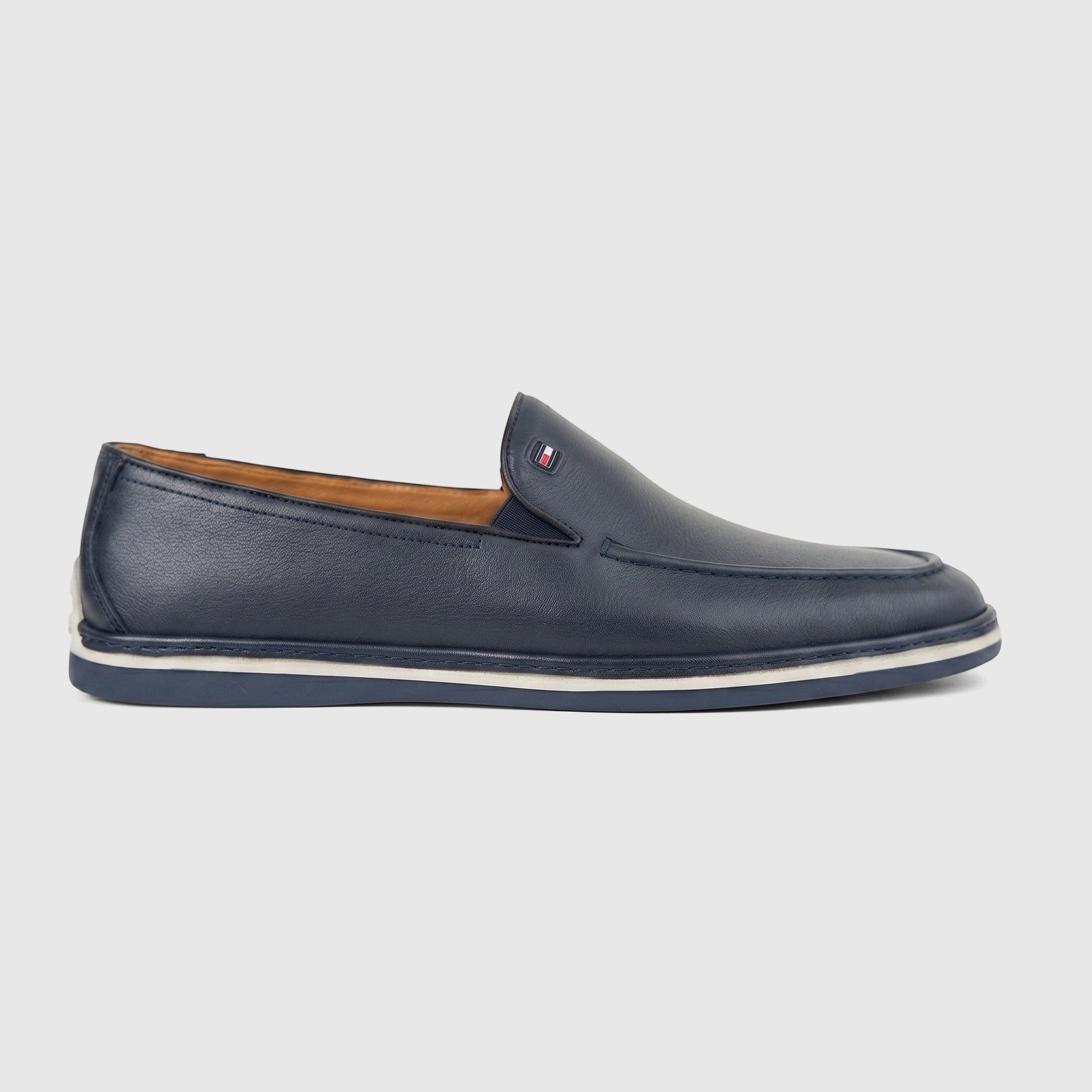 Men's Formales navy blue leather loafer with white sole detailing, featuring a small logo emblem, viewed from the side.