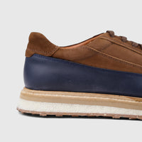 Close-up side view of Formales Men's Suede Sneaker 4742 in navy and tan, showcasing the distinct material textures.