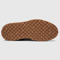 Bottom view of a Formales men's suede sneaker sole, featuring a brown speckled recycled material with a square patterned