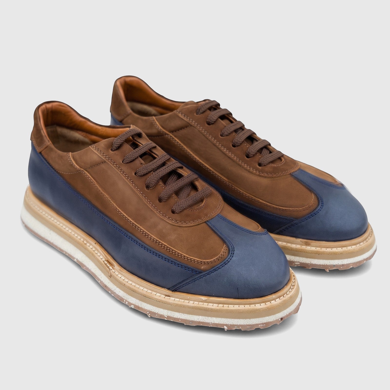 Formales Men's Suede Sneaker 4742 in navy blue leather and tan brown suede with brown laces, presented from a side angle.