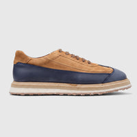 Formale's Men's Suede Sneaker in navy and tan, featuring visible laces and a layered sole, shown in a side view.