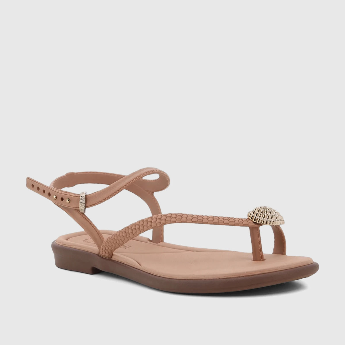 Grendha Icone women's flat sandal in a natural beige-brown color, featuring a braided strap and metallic embellishment.