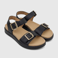 A pair of Hotter Ladies Comfort Corfu black leather sandals with gold buckles, viewed from an elevated angle.
