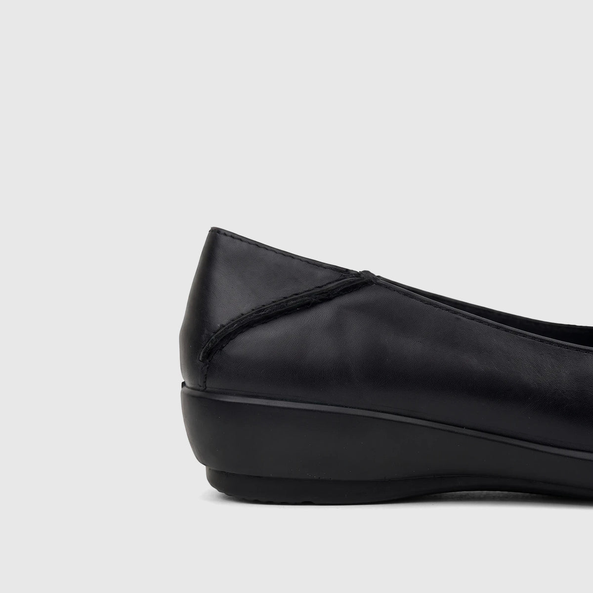 Black leather Hotter Ladies Comfort Pump Birdie shoe, featuring a soft heel design and low wedge sole, viewed from the side.