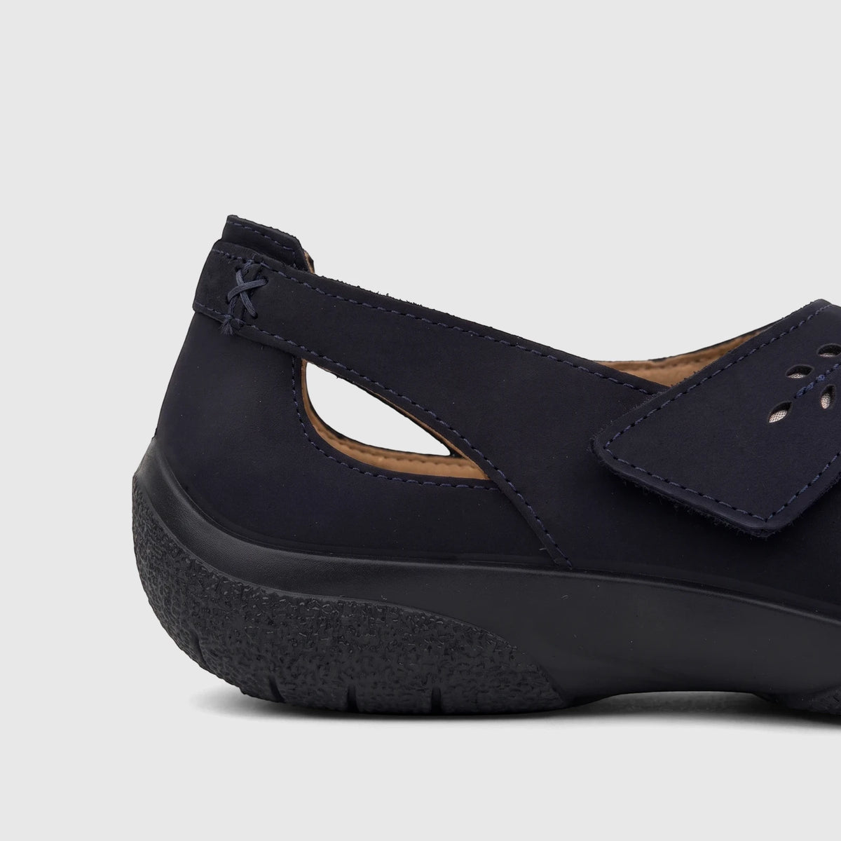 Side view of a Hotter Ladies Comfort Pump Daphne Navy shoe with a perforated strap and textured sole.
