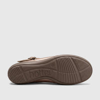 The brown rubber sole of a Hotter Ladies Comfort Pump in rosegold, viewed from the side, showing the molded 'hotter' logo