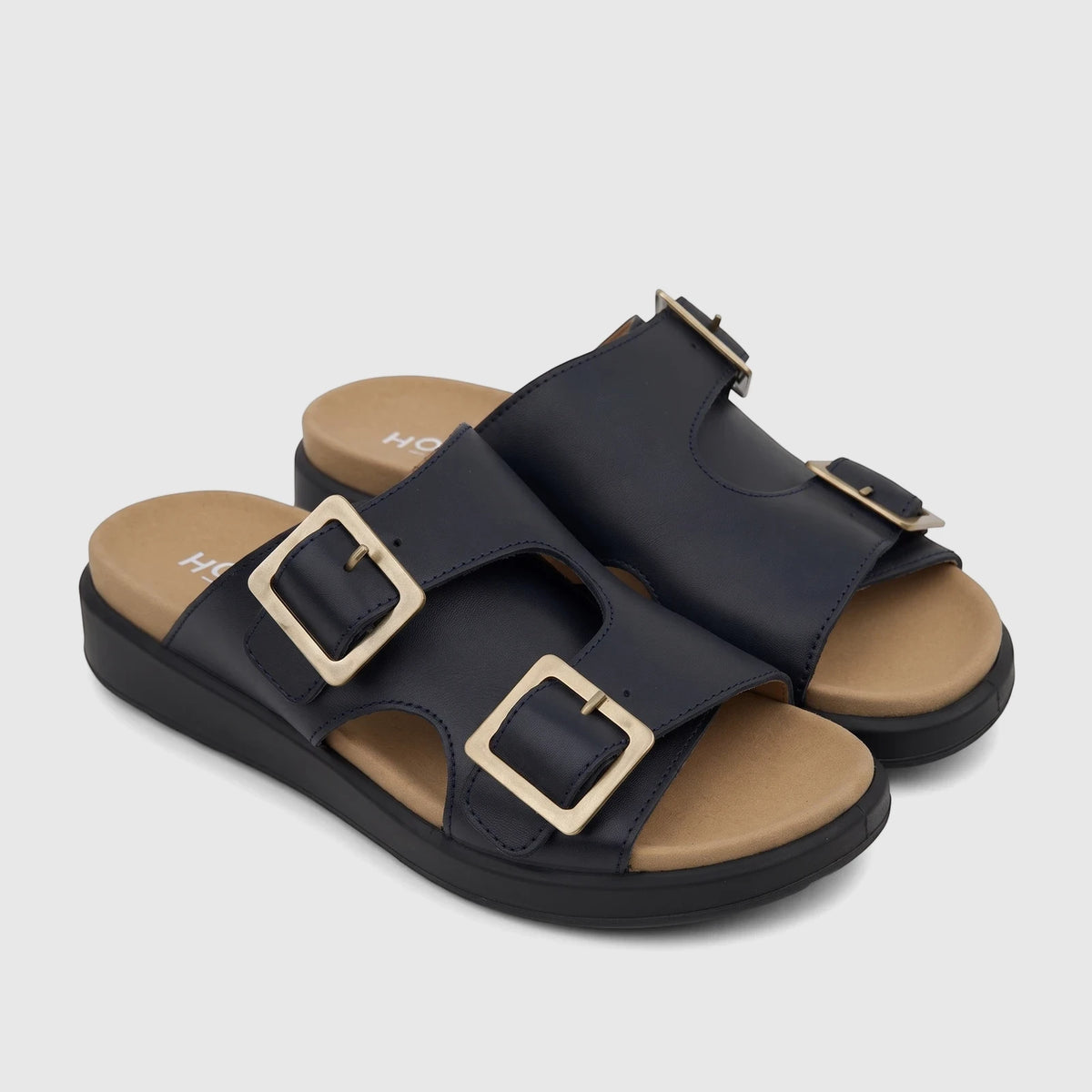 Pair of navy blue Hotter Comfort Sandals Corsica with two gold buckles on each strap, tan insoles, and black soles.