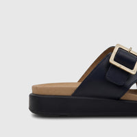 Close-up side view of a navy Hotter Comfort Sandal Corsica HT106, featuring a tan footbed and a rectangular gold buckle.