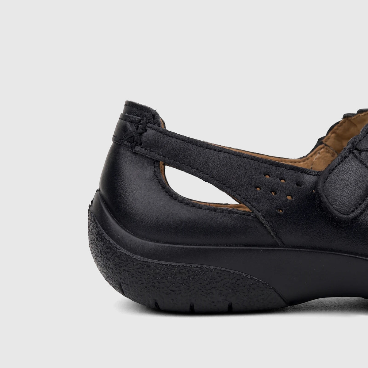 Hotter Ladies Comfort Shoe Quake 2 Black HT103 in a side view, featuring black perforated leather and a braided strap.