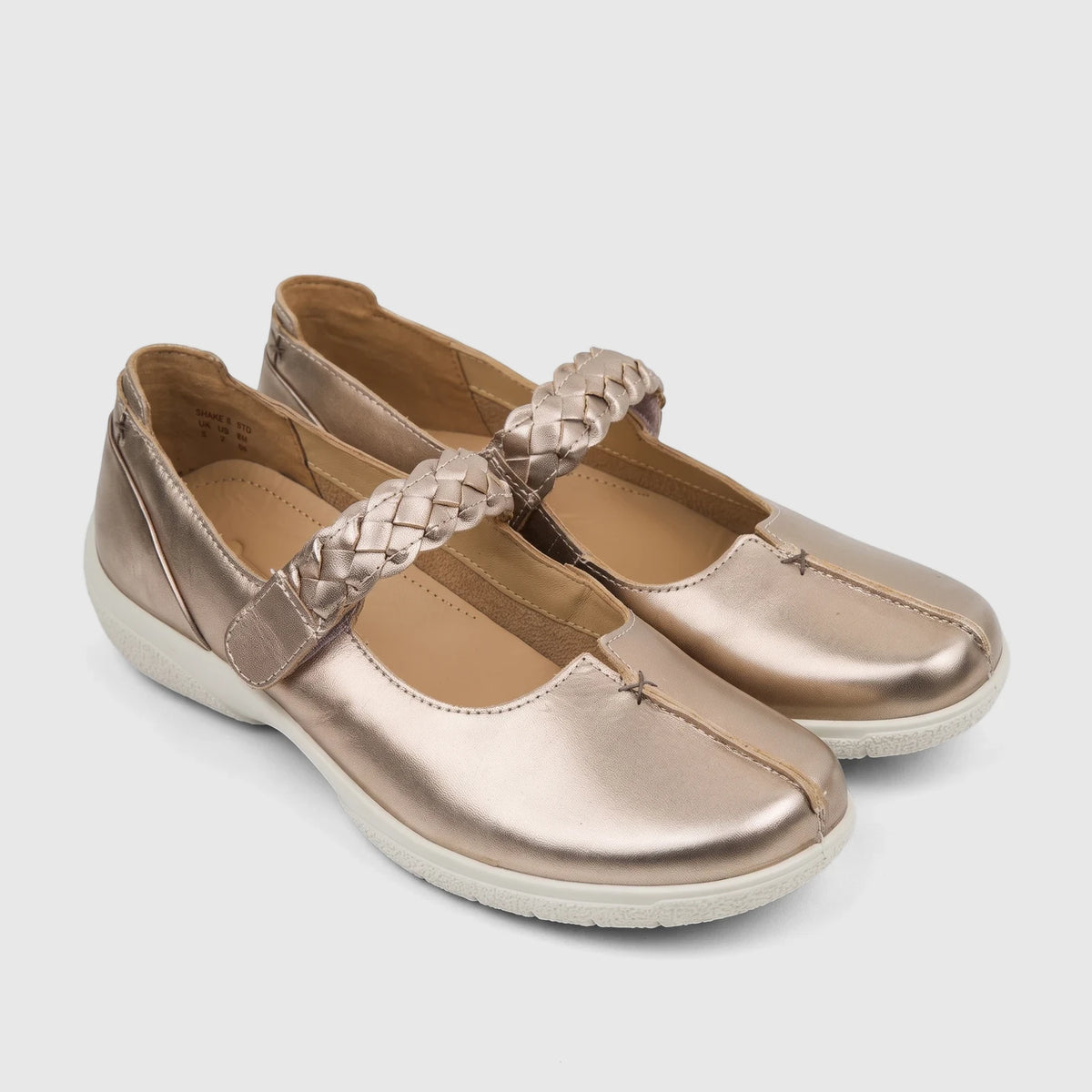 Pair of Hotter Ladies Comfort Shoe Shake 2 in rose gold leather with braided straps and white soles, presented from a