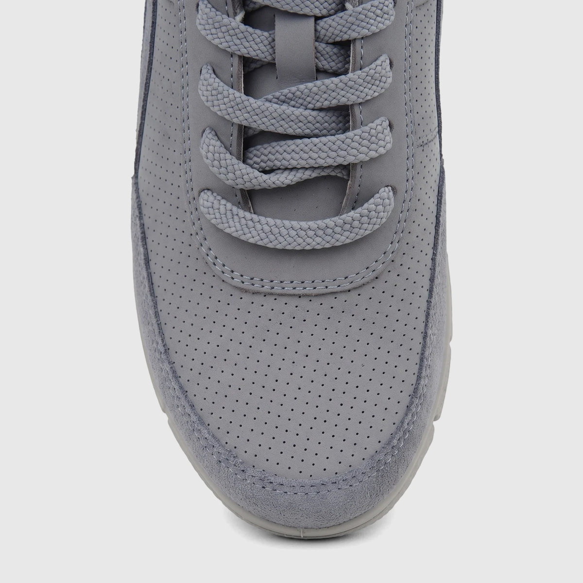 A close-up shot of the front of a grey perforated Hotter Ladies Comfort Sneaker, showcasing the toe box and laces.