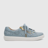 Light blue perforated leather women's comfort sneaker with gold zippers and laces, viewed from the side.