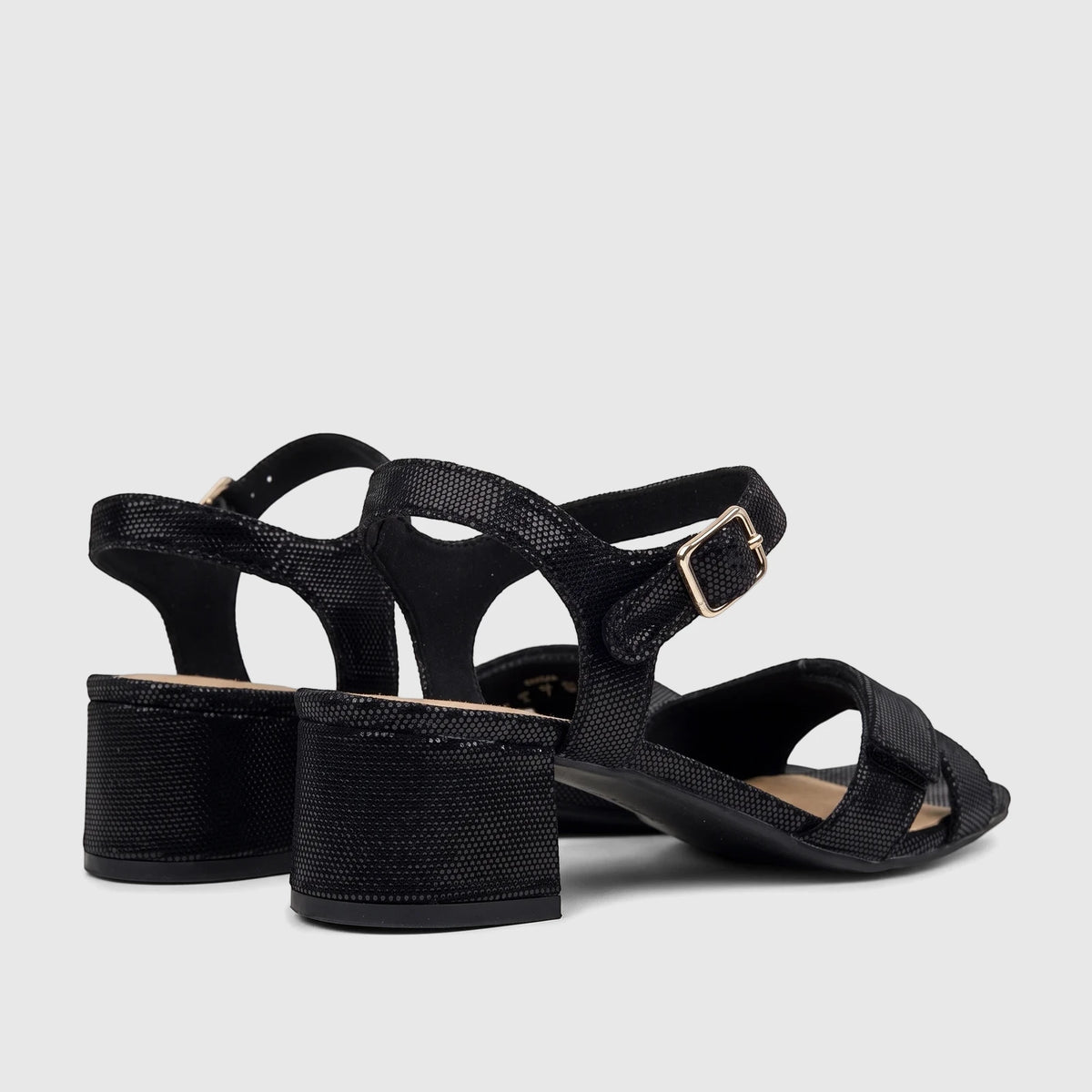 Pair of Hotter Riviera black block heel sandals with textured straps and a gold buckle, viewed from a slightly elevated rear