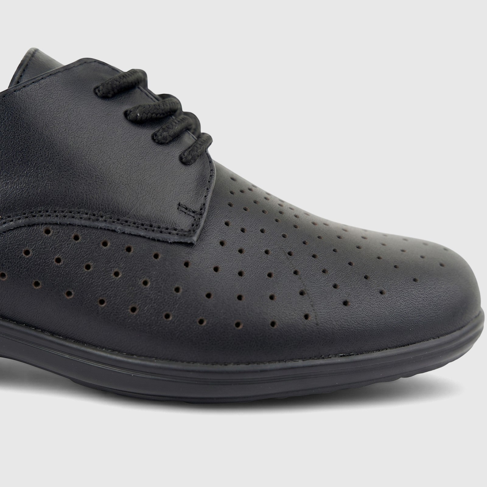 Black leather HP Ladies Comfort lace-up shoe with perforated details and a comfort sole, viewed from a side angle.