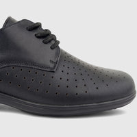 Close-up of a black perforated comfort lace-up shoe, featuring visible laces and textured material on a neutral background.