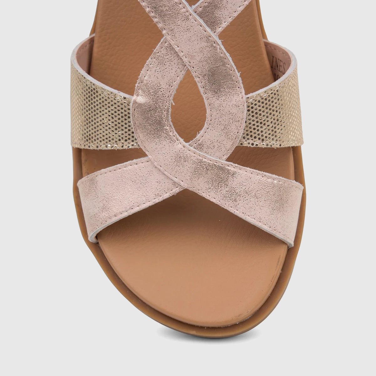 Close-up of a pink metallic and gold HP Ladies Comfort Sandal with criss-cross straps, showing textured details and a soft